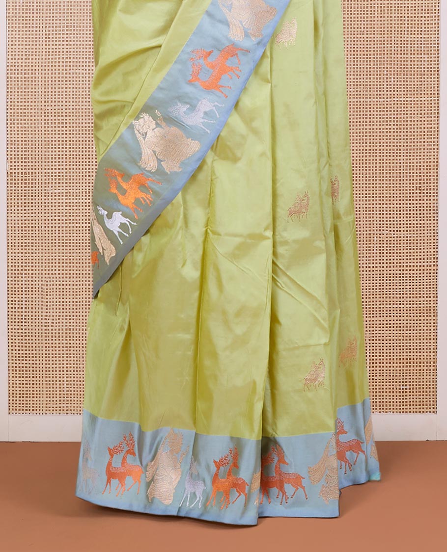 Green katan silk saree with deer motifs, contrast border of deer & human motifs & pallu with deer motif enclosed checks