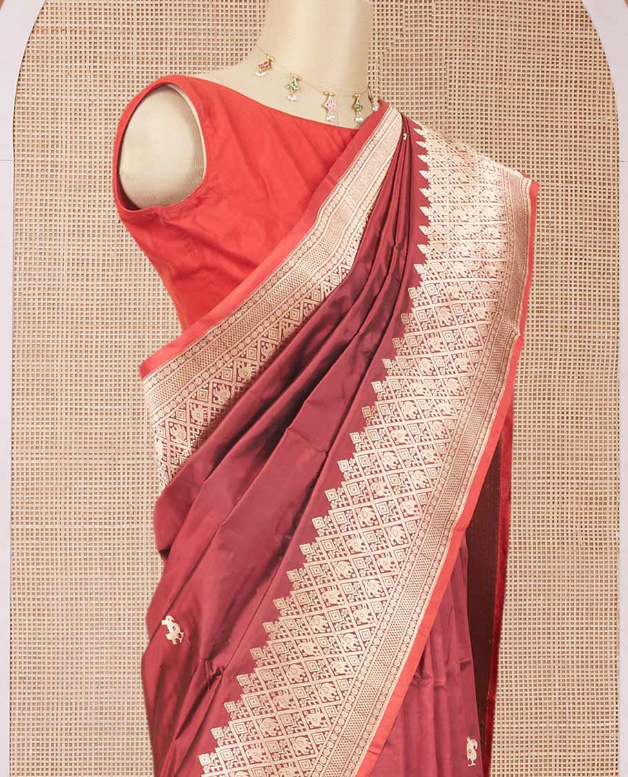 Maroon katan silk saree with patola-style zari buttas, zari border & pallu of patola-style animal motifs enclosed checks