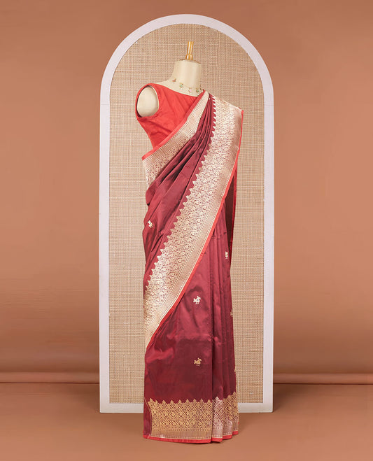 Maroon katan silk saree with patola-style zari buttas, zari border & pallu of patola-style animal motifs enclosed checks