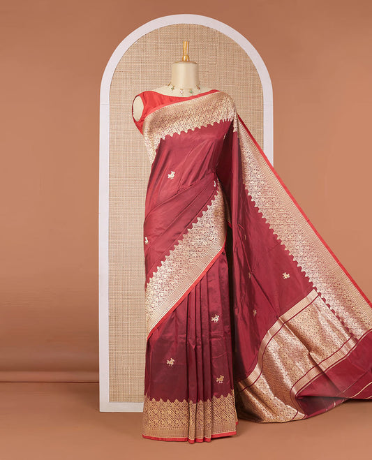 Maroon katan silk saree with patola-style zari buttas, zari border & pallu of patola-style animal motifs enclosed checks