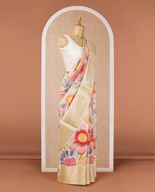 Cream base chiniya silk saree with multi-color, uniquely-shaped floral prints, traditional zari design border