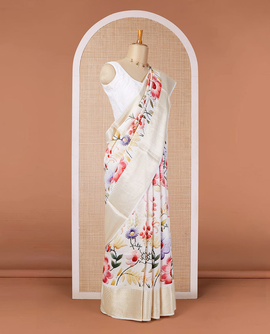 Cream digital printed chiniya silk saree with colorful floral motifs, traditional zari border & zari pallu