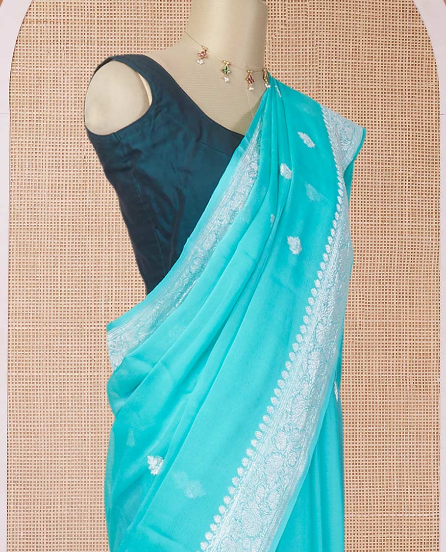 Turquoise banarasi georgette saree with zari buttas, floral creeper zari border & pallu of paisleys