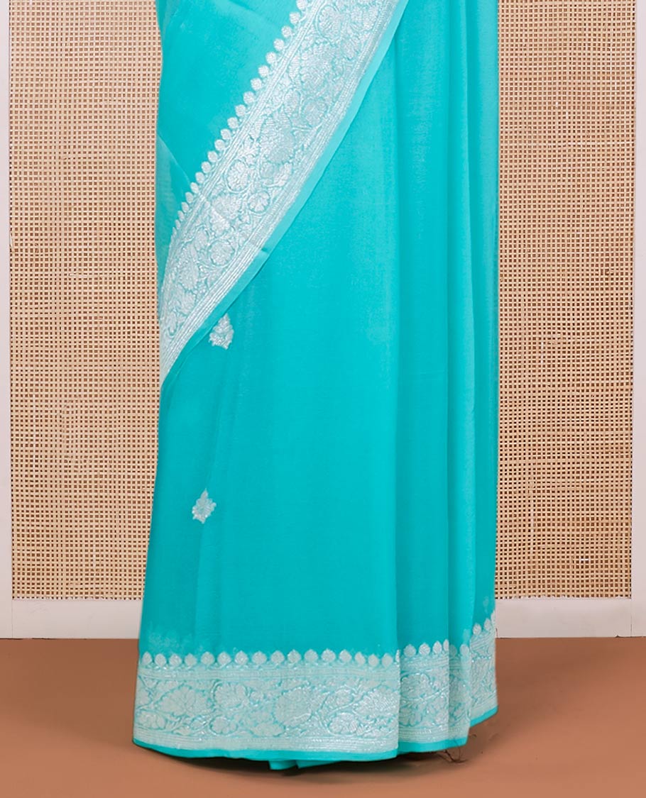 Turquoise banarasi georgette saree with zari buttas, floral creeper zari border & pallu of paisleys
