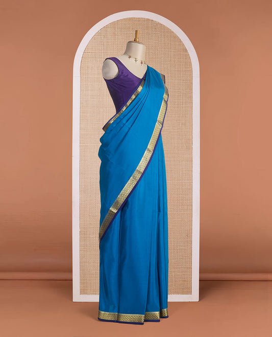Blue plain Mysore silk saree, contrast golden zari border woven in traditional motifs & zari striped pallu