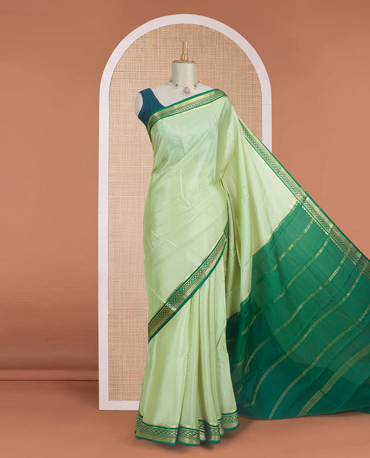 Tea green color plain Mysore silk saree with contrast geometric zari design borders and pallu of zari seer lines