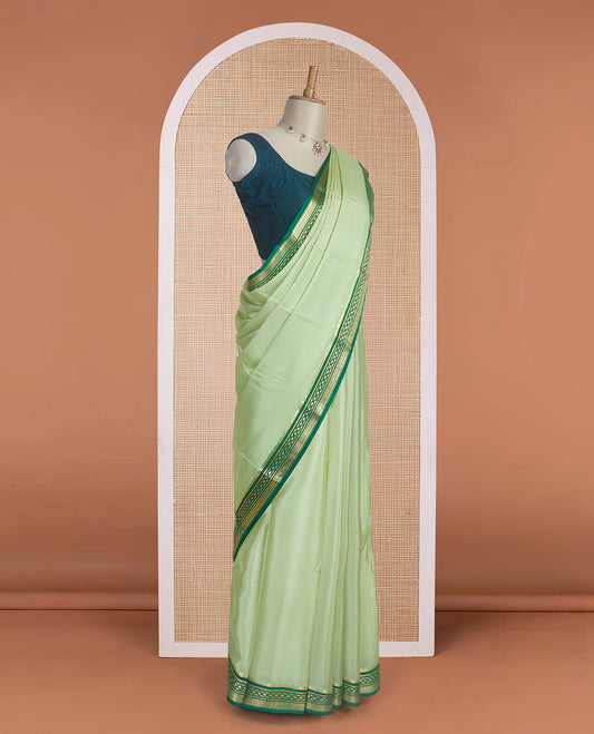 Tea green color plain Mysore silk saree with contrast geometric zari design borders and pallu of zari seer lines