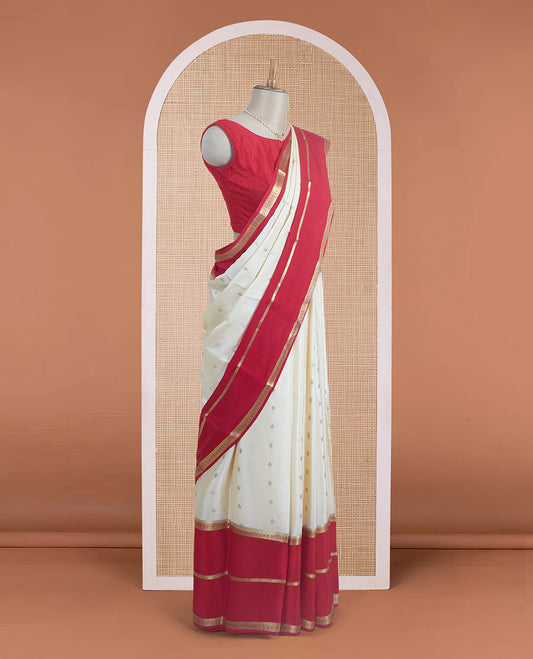 Cream zari buttas steeped Mysore silk saree, contrast rettai pettu traditional zari border, and pallu of temple design in golden zari