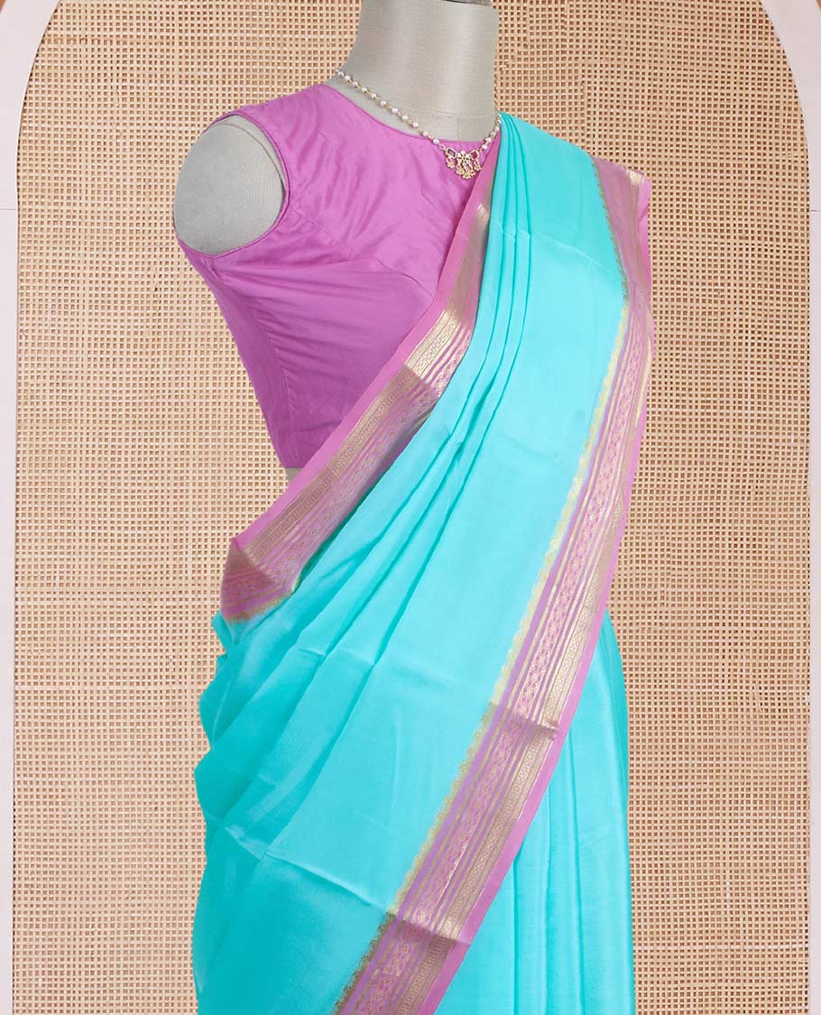 Light blue plain Mysore silk saree, contrast traditional zari motifs woven pink border, and zari striped pallu