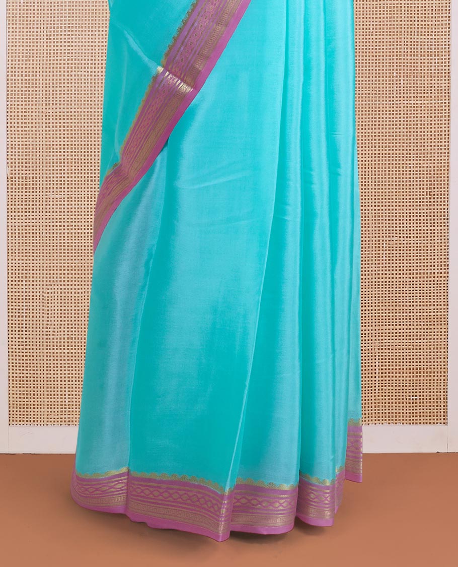Light blue plain Mysore silk saree, contrast traditional zari motifs woven pink border, and zari striped pallu