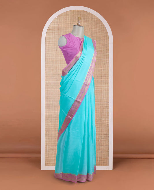 Light blue plain Mysore silk saree, contrast traditional zari motifs woven pink border, and zari striped pallu