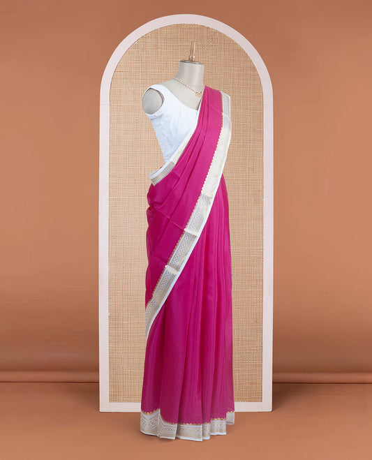 Dark pink plain body Mysore silk saree, contrast border adorned with traditional motifs in zari, and pallu of zari stripes