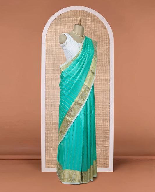 Turquoise zari buttas Mysore silk saree, contrast peacock and chakram zari border, and pallu steeped with traditional zari designs