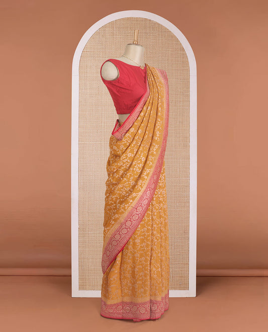 Yellow floral jaal jacquard banarasi georgette saree, contrast floral creeper zari border, and pallu of floral jaal design
