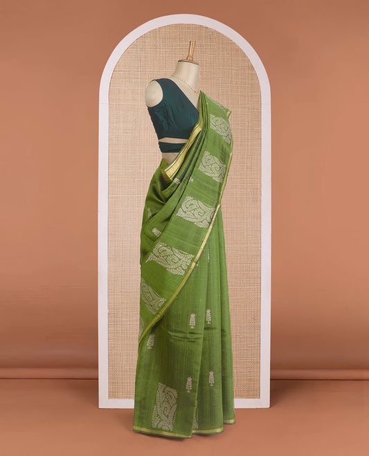 Green dupion silk saree with floral buttas, thin zari piping border, and floral vine pallu
