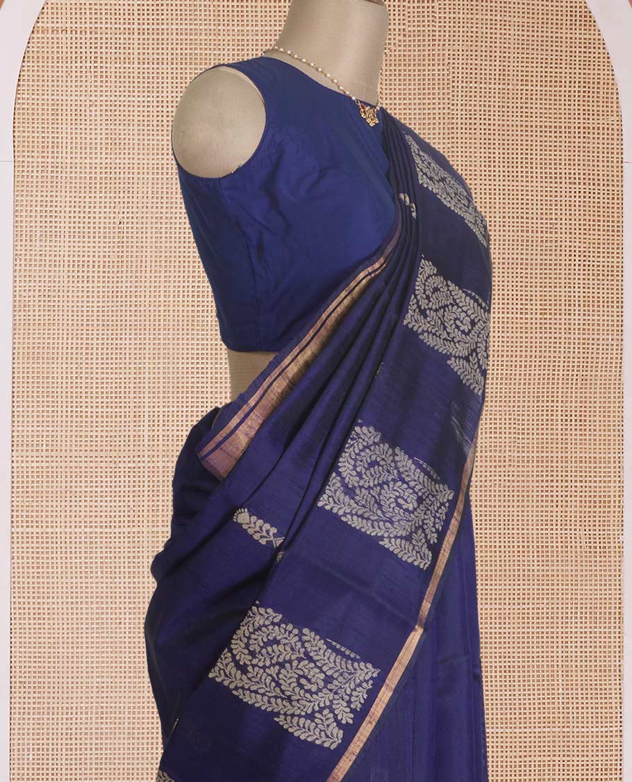 Navy blue dupion silk saree with floral buttas, thin zari piping border, and floral vine pallu