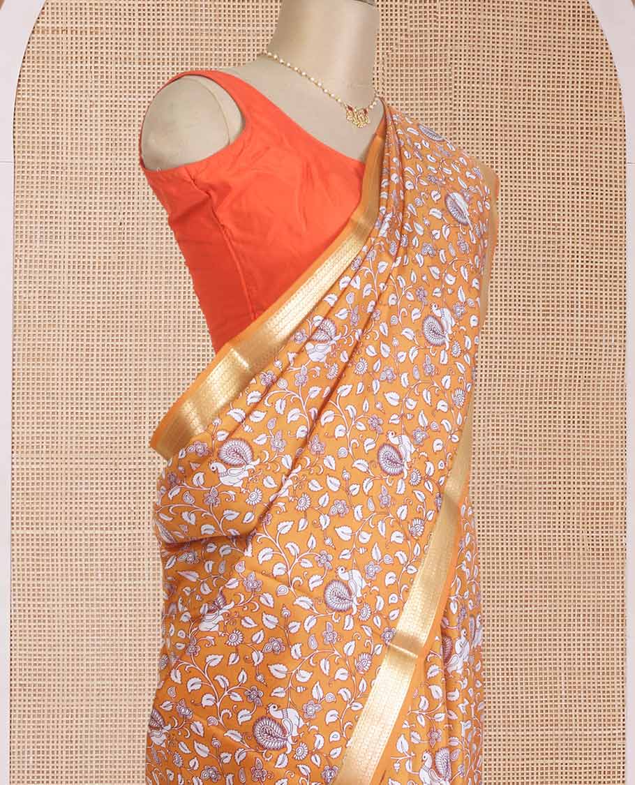 Orange kalamkari floral vine, and peacock printed silk saree, paisley zari motifs border, and striped pallu