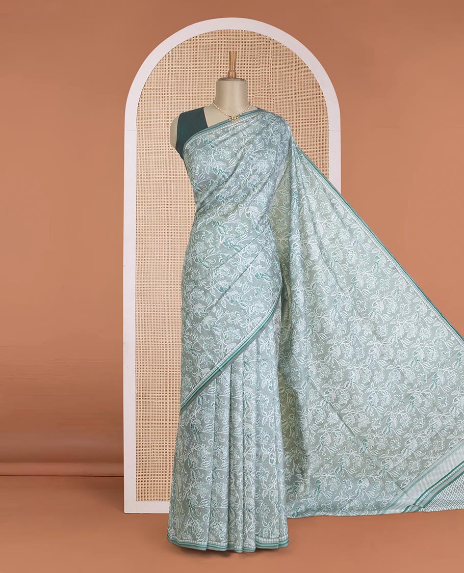 Pastel green floral vine printed silk saree, geometric printed border, and geometric printed pallu