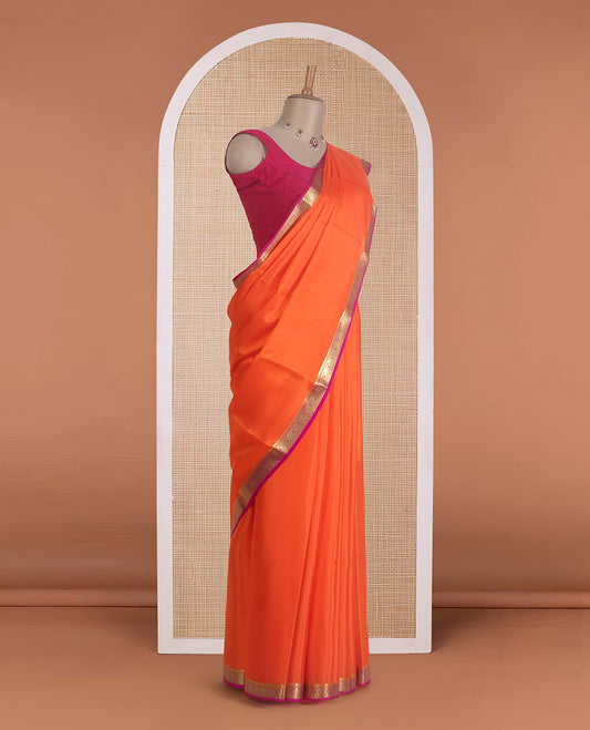 Jalebi orange plain Mysore silk saree, contrast Mughal style zari border, and zari striped pallu