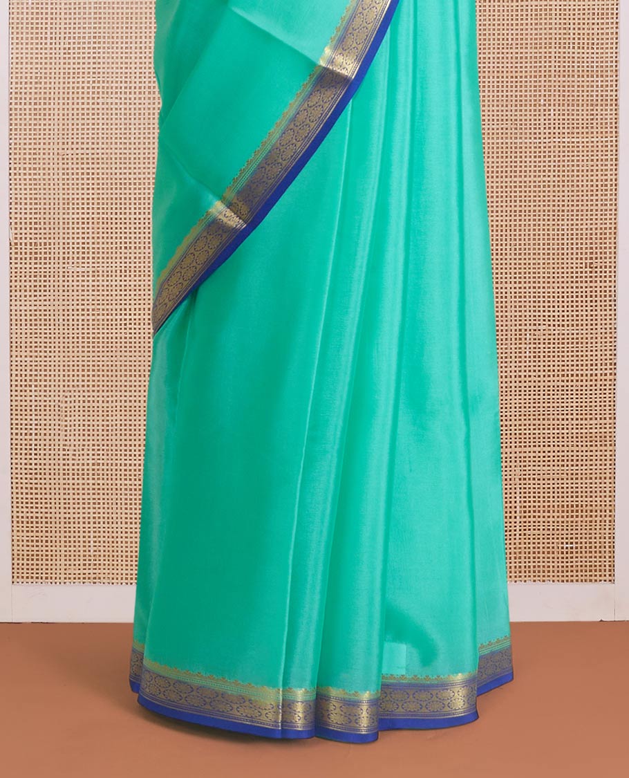 Seafoam green plain Mysore silk saree, contrast traditional zari border, and zari striped pallu