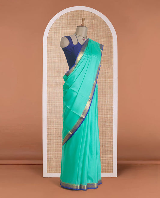 Seafoam green plain Mysore silk saree, contrast traditional zari border, and zari striped pallu