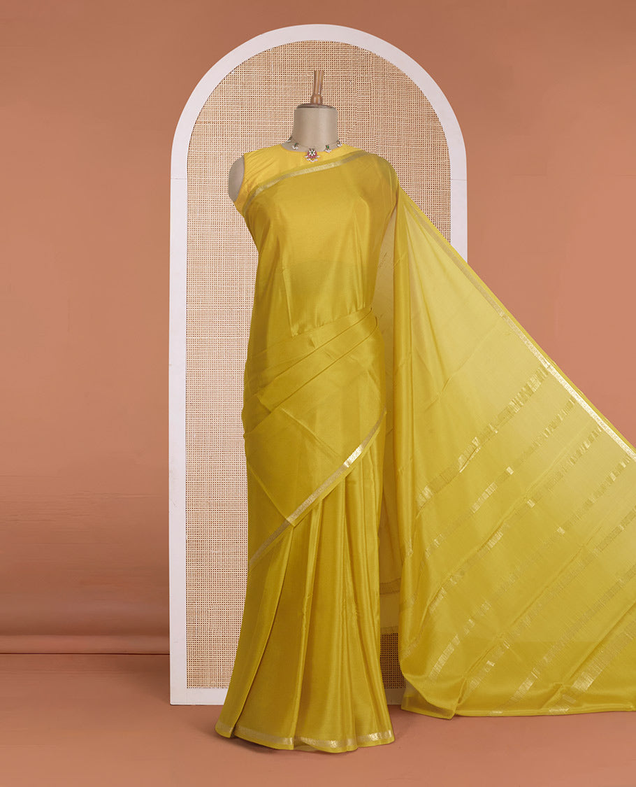 Yellow plain Mysore silk saree, traditional zari border, and zari striped pallu