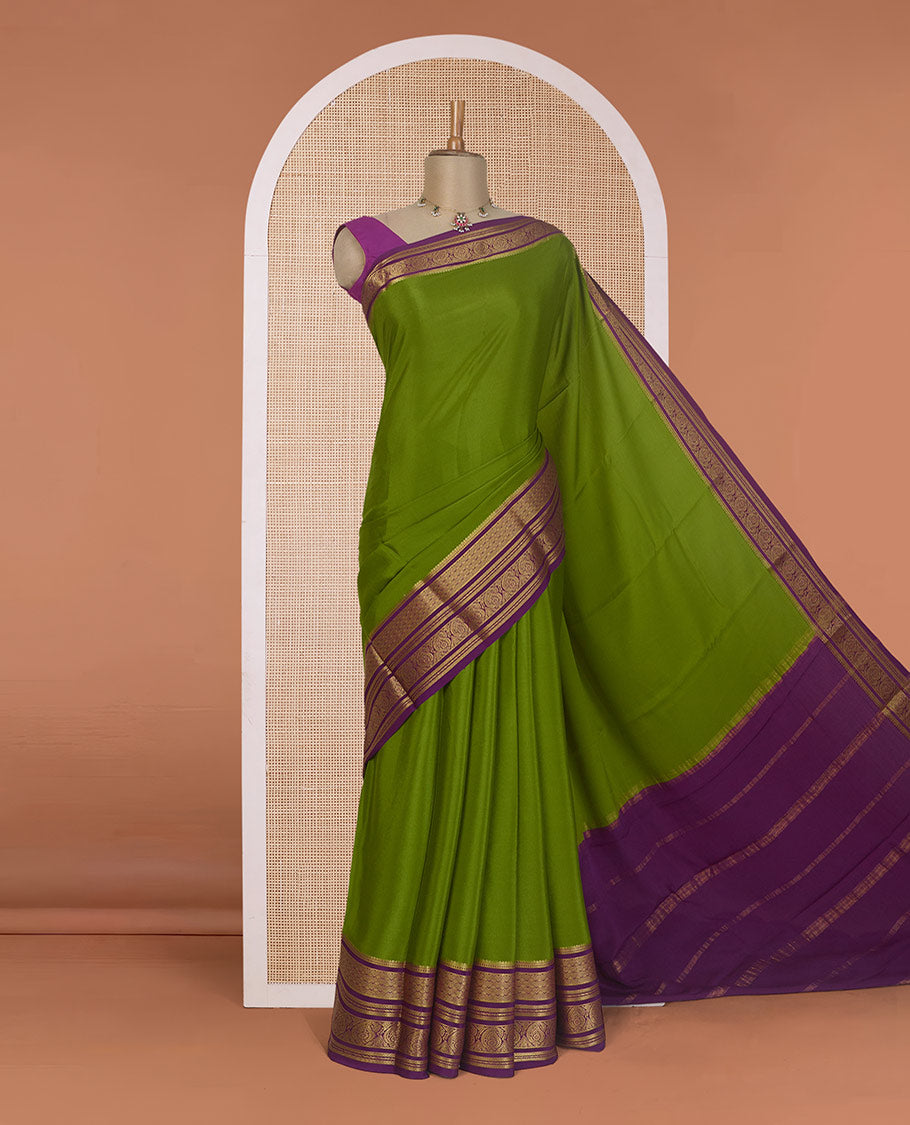 Green plain Mysore silk saree, contrast traditional zari border of paisleys, and zari striped pallu