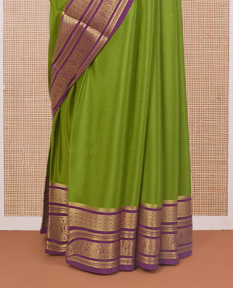Green plain Mysore silk saree, contrast traditional zari border of paisleys, and zari striped pallu