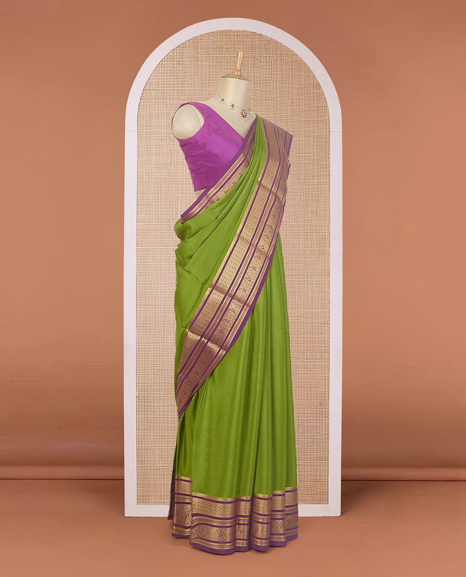 Green plain Mysore silk saree, contrast traditional zari border of paisleys, and zari striped pallu