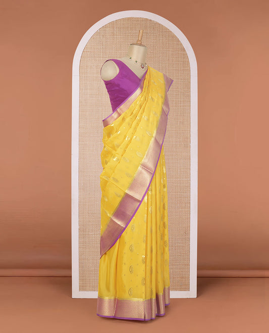 Yellow paisley buttas Mysore silk saree, contrast traditional zari border, and jaal design pallu