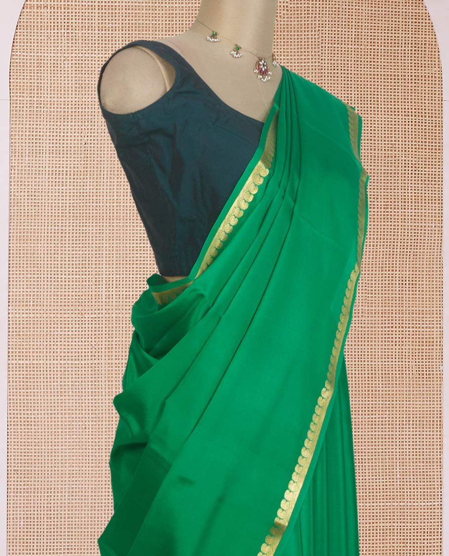 Green plain Mysore silk saree, zari border of paisleys, and zari striped pallu