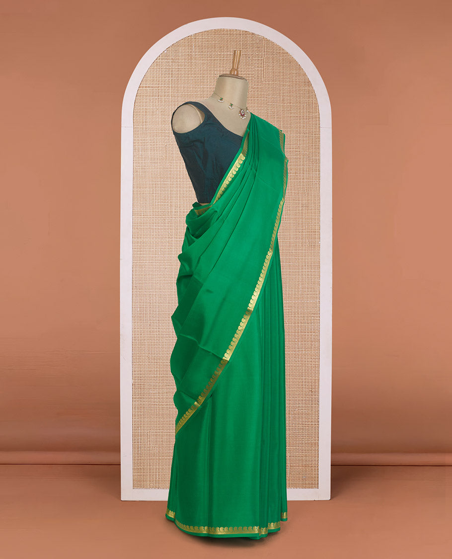Green plain Mysore silk saree, zari border of paisleys, and zari striped pallu