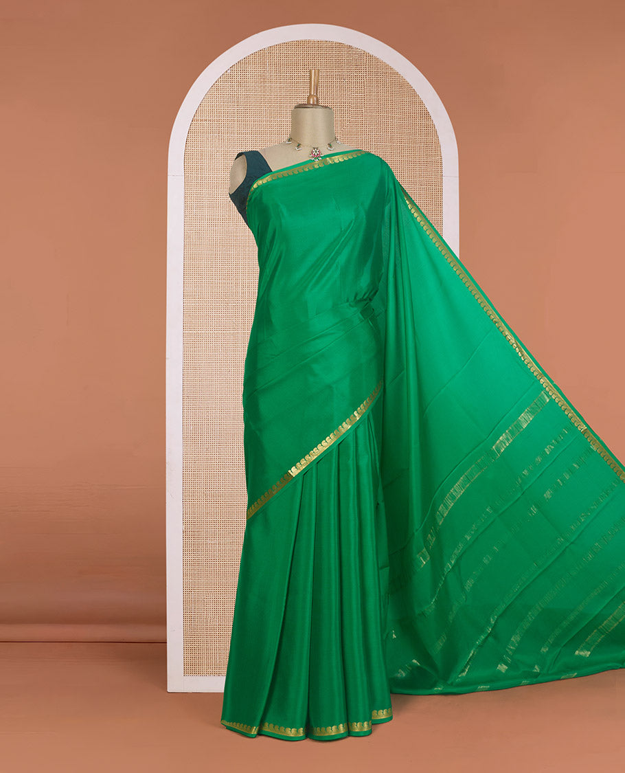 Green plain Mysore silk saree, zari border of paisleys, and zari striped pallu