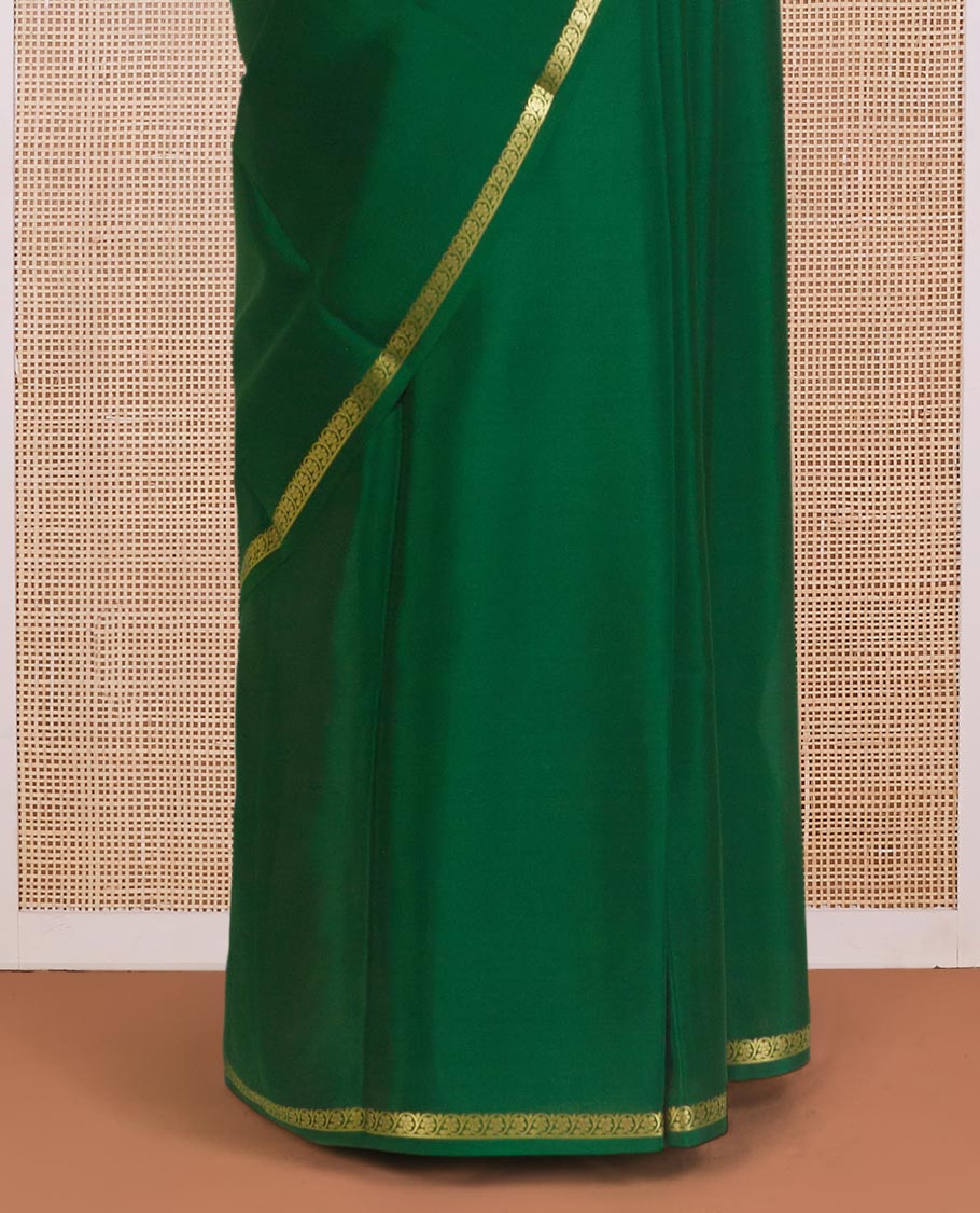 Dark green plain Mysore silk saree, zari border of floral creeper designs, and zari striped pallu