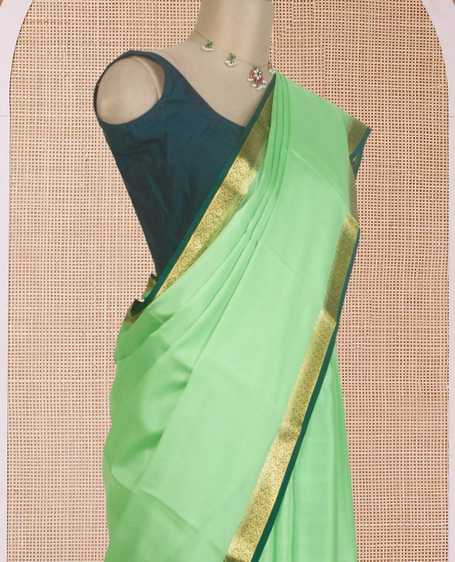 Pista green plain Mysore silk saree, contrast zari border of traditional designs, and zari striped pallu