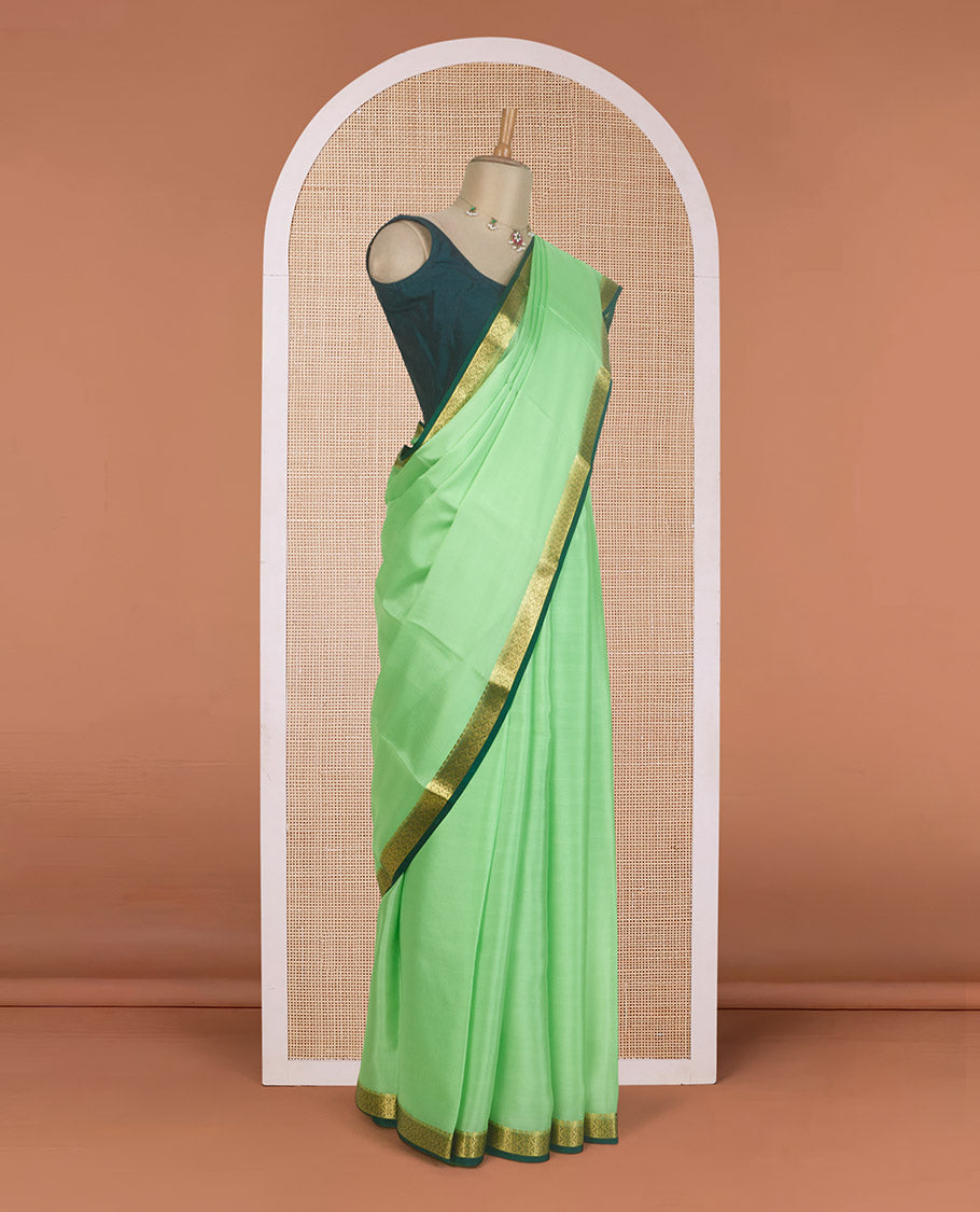 Pista green plain Mysore silk saree, contrast zari border of traditional designs, and zari striped pallu