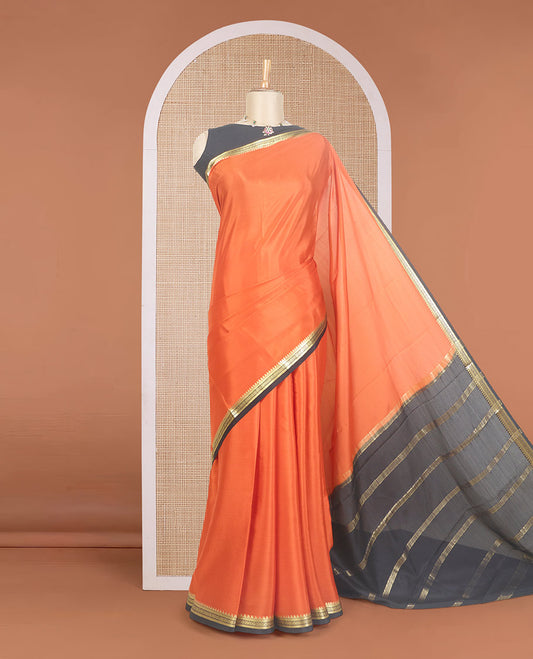 Orange plain Mysore silk saree, contrast traditional zari design border, and zari striped pallu