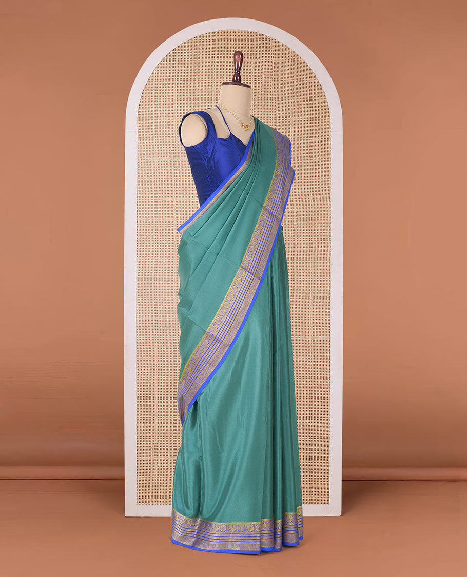 Green plain Mysore silk saree, contrast traditional zari border of Peacock and chakram and pallu of traditional designs