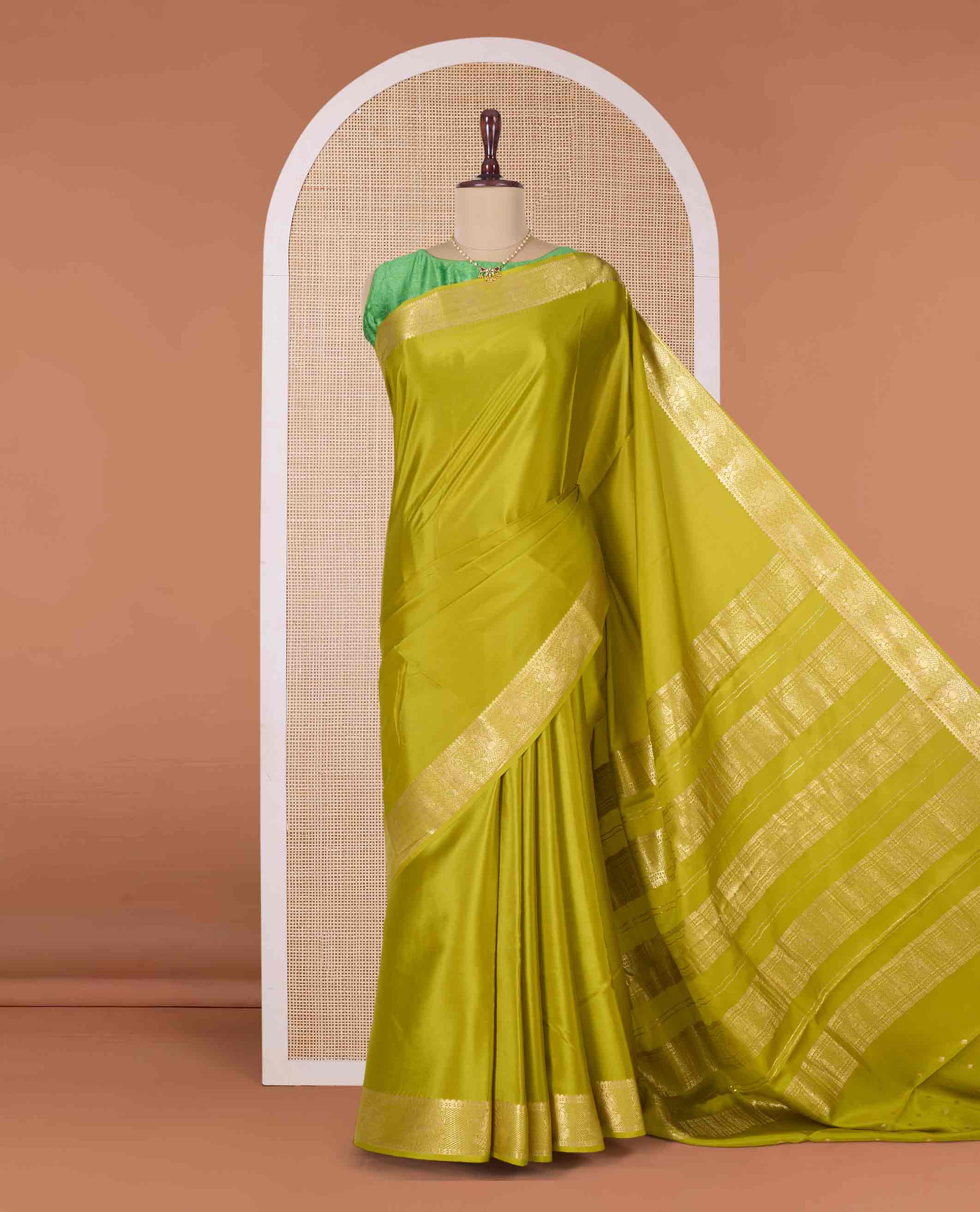 Green plain Mysore silk saree, zari border of two-headed eagle motifs, and pallu of zari designs