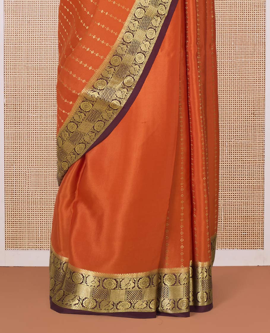 Orange zari buttas Mysore silk saree, contrast peacock chakram zari buttas border, and pallu steeped with traditional designs