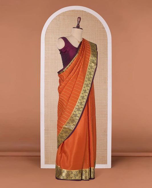 Orange zari buttas Mysore silk saree, contrast peacock chakram zari buttas border, and pallu steeped with traditional designs