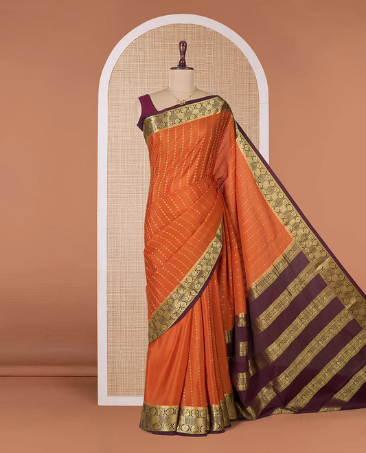 Orange zari buttas Mysore silk saree, contrast peacock chakram zari buttas border, and pallu steeped with traditional designs