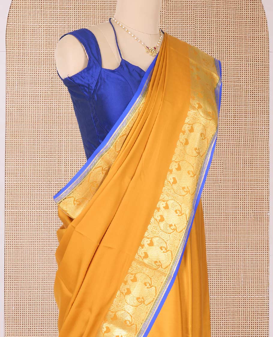 Yellow plain Mysore silk saree, two-headed eagle zari border, and pallu steeped with two-headed eagle motifs