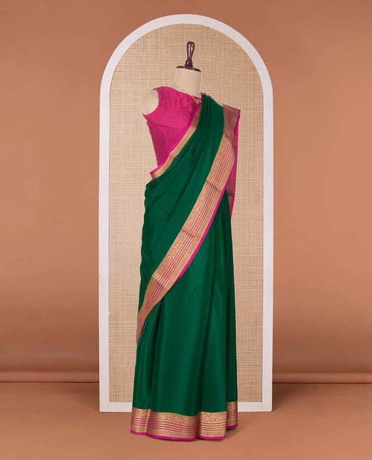 Green plain Mysore silk saree, contrast Peacock and chakram border, and pallu of traditional zari designs