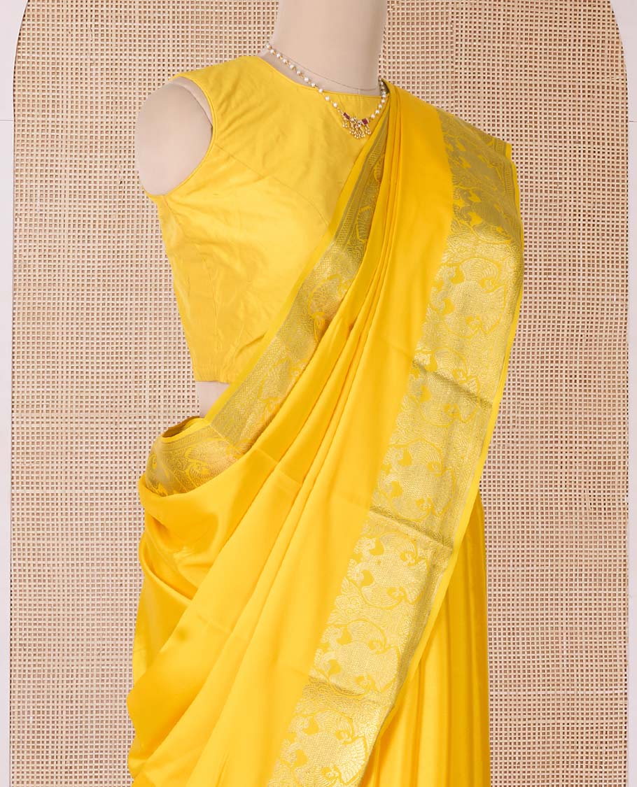 Yellow plain Mysore silk saree, two-headed eagle zari border, and pallu steeped with two-headed eagle motifs