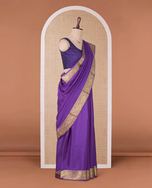 Purple embossed Mysore silk saree, traditional peacock motifs zari woven border, and pallu of traditional designs