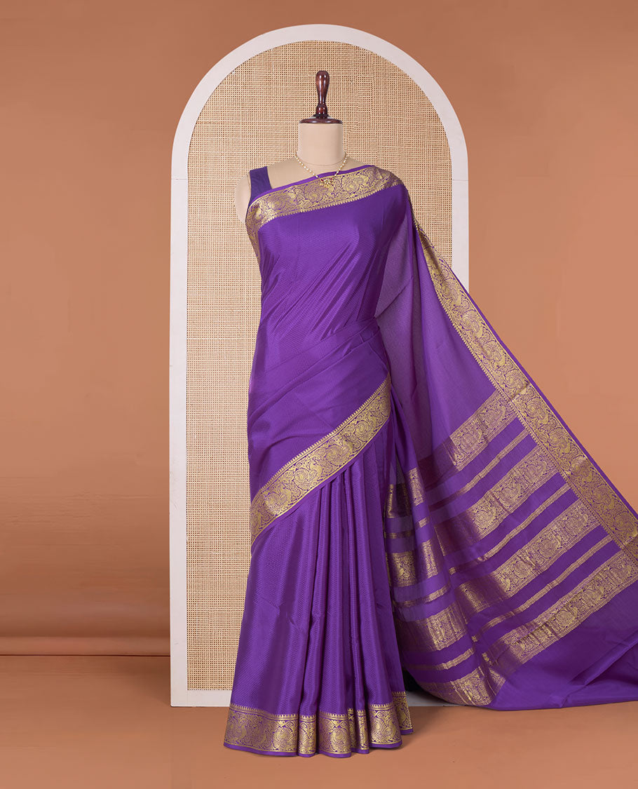 Purple embossed Mysore silk saree, traditional peacock motifs zari woven border, and pallu of traditional designs