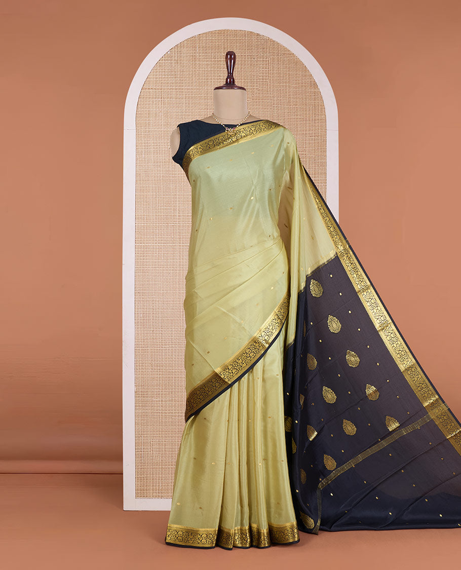 Pale green zari buttas Mysore silk saree, contrast floral vine design border, and thilakam motifs pallu