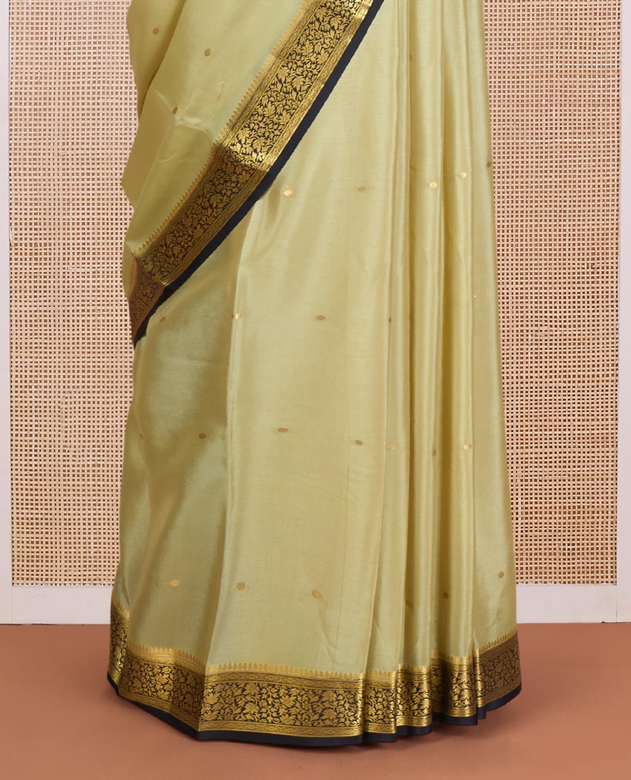 Pale green zari buttas Mysore silk saree, contrast floral vine design border, and thilakam motifs pallu