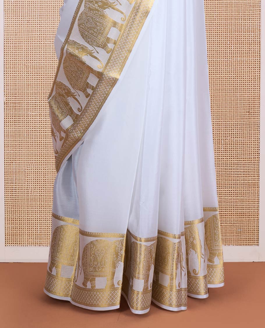 Cream plain Mysore silk saree, traditional zari border of elephant motifs, and pallu steeped with manga designs